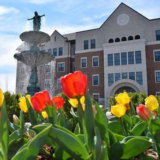 Our Lady of Grace Fountain surrounded by flowers